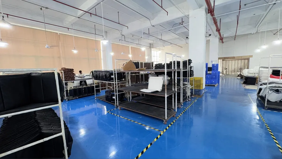 Metal racks holding upholstered furniture components on a workshop floor